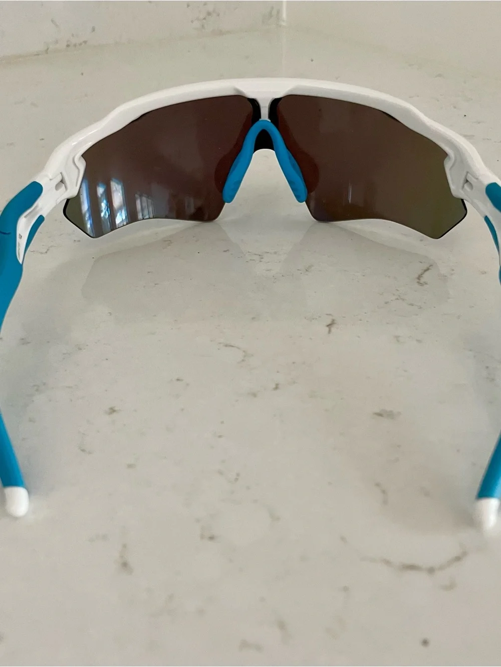 Oakley White Frame Sunglasses with Blue Lenses and Blue Temple Tips